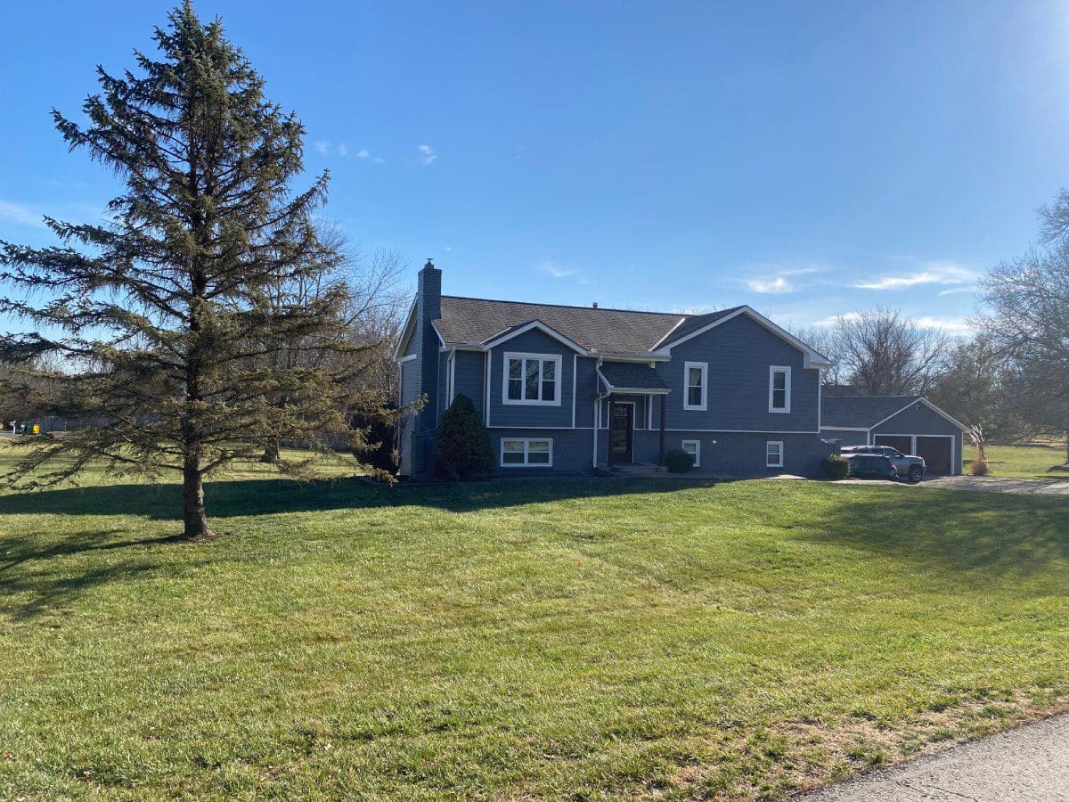 A large house with a tree in the yard