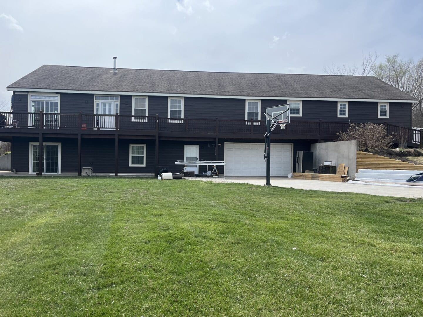 A large house with a basketball hoop in the yard.