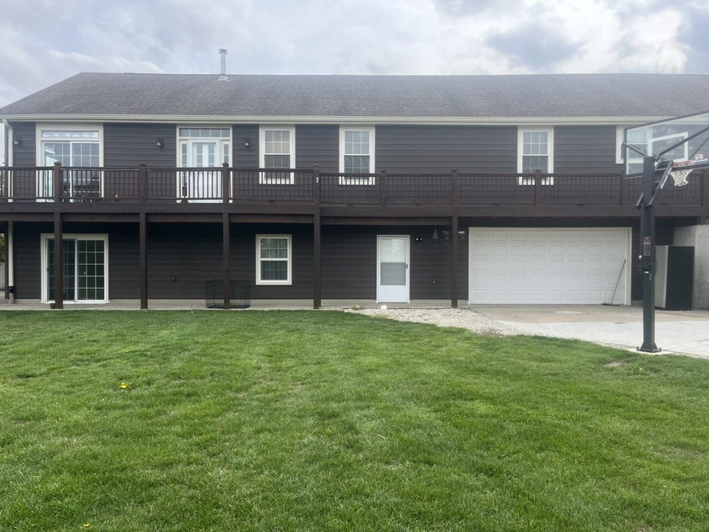 A large brown house with grass in front of it.