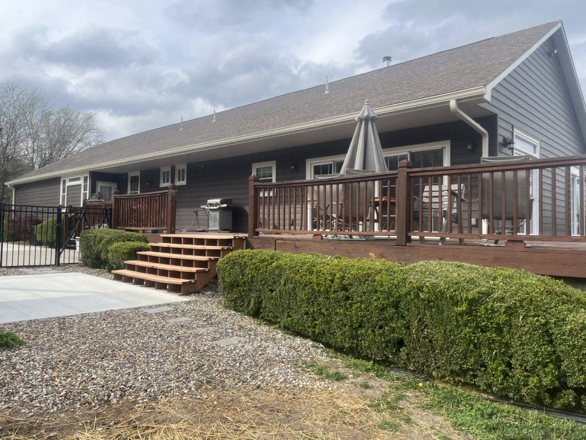 A large house with a deck and patio area.