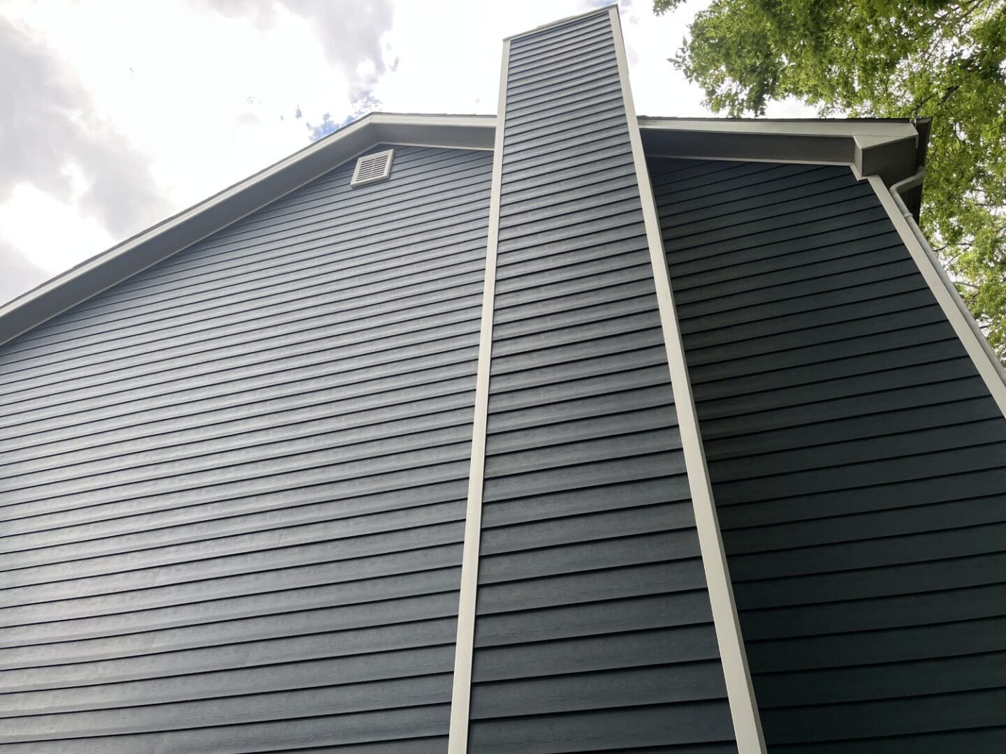 A close up of the side of a house with a gutter