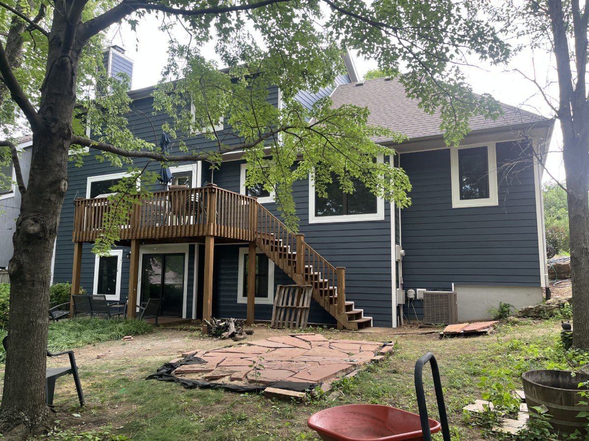 A house with stairs and steps in the back yard.